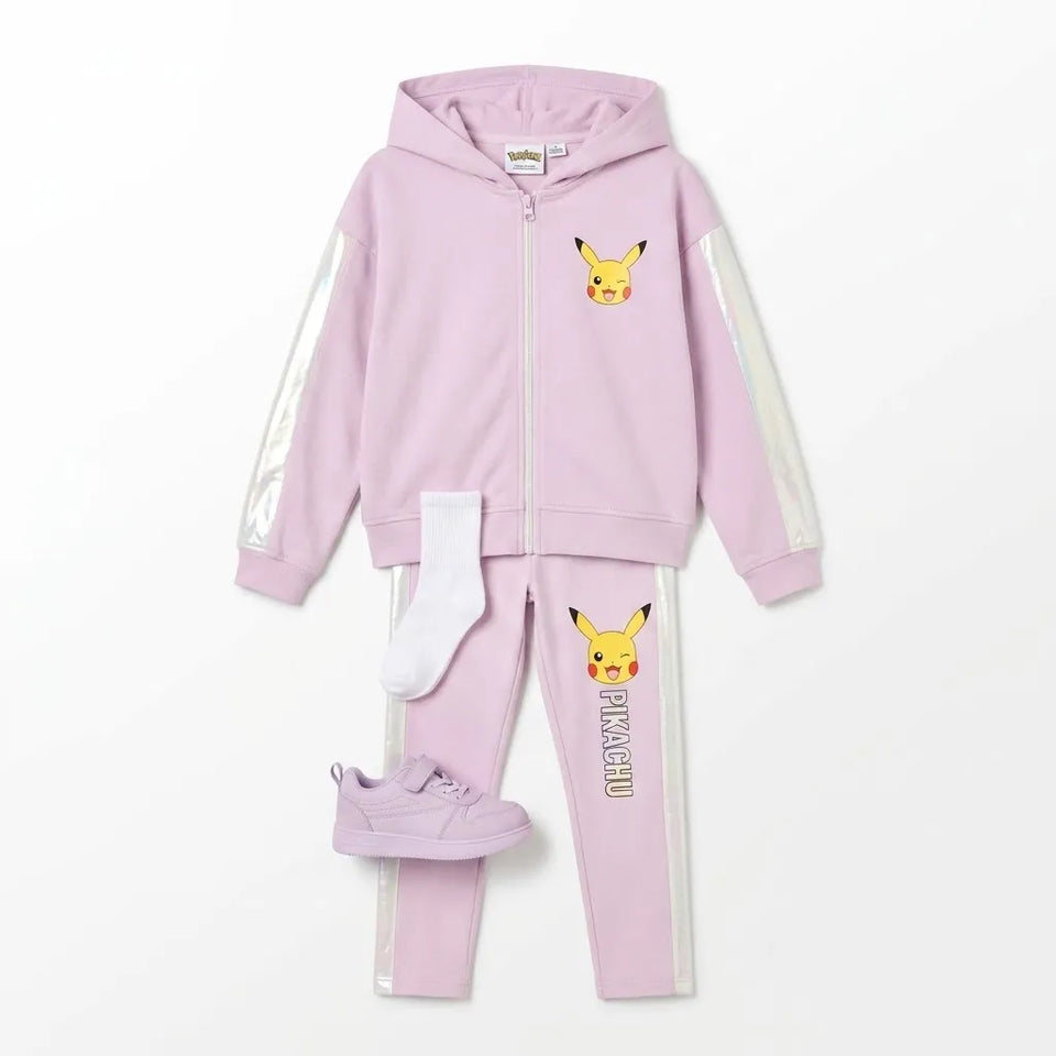 A children's two-piece tracksuit in light pink, featuring a zip-up hoodie with reflective silver sleeves and a Pikachu graphic on the chest, matching pink joggers with a vertical Pikachu print and white side stripes, plus a pair of white socks and matching pink sneakers, laid out on a white background.