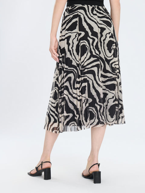 Person wearing a patterned skirt on a white background