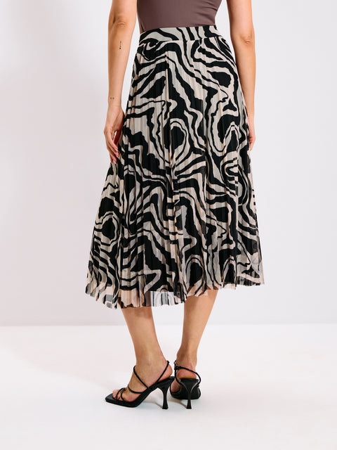 Person wearing a zebra print skirt on a plain background