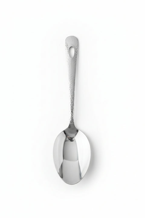 Silver spoon on a wooden surface