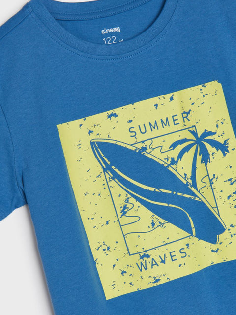 Blue t-shirt with 'Summer Waves' graphic design featuring a surfboard and palm tree on a yellow background.