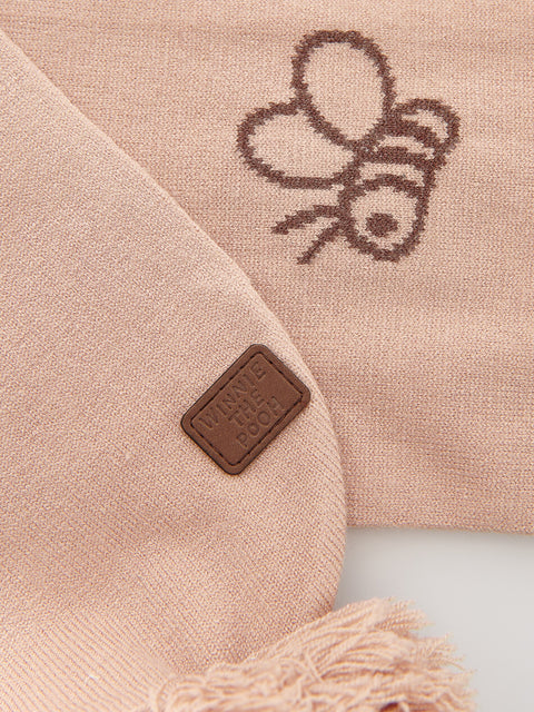 Beige scarf with a bee design and a brown label on a light background