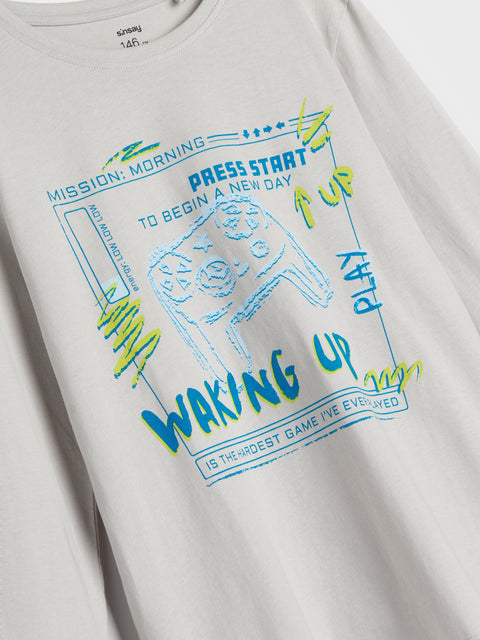 White t-shirt with colorful graphic design on a plain background