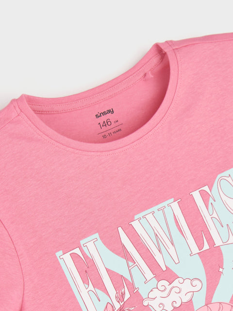 Pink t-shirt with blue text and graphics on a light gray background