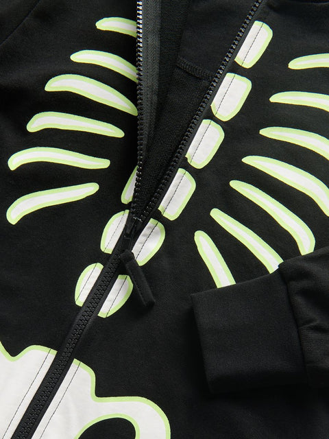 Black jacket with reflective skeleton design on a dark background