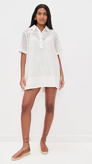 Woman wearing a white lace dress on a white background