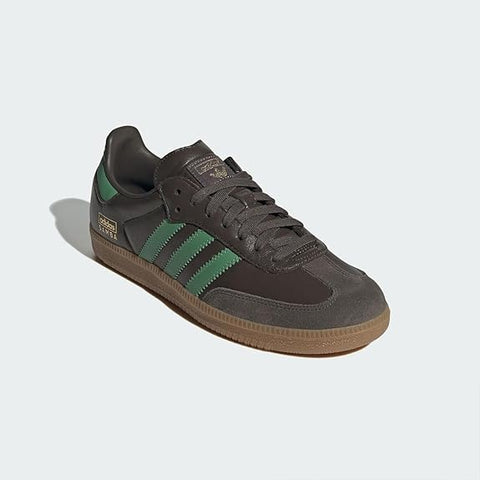 Gray Adidas sneaker with green stripes on a light gray background