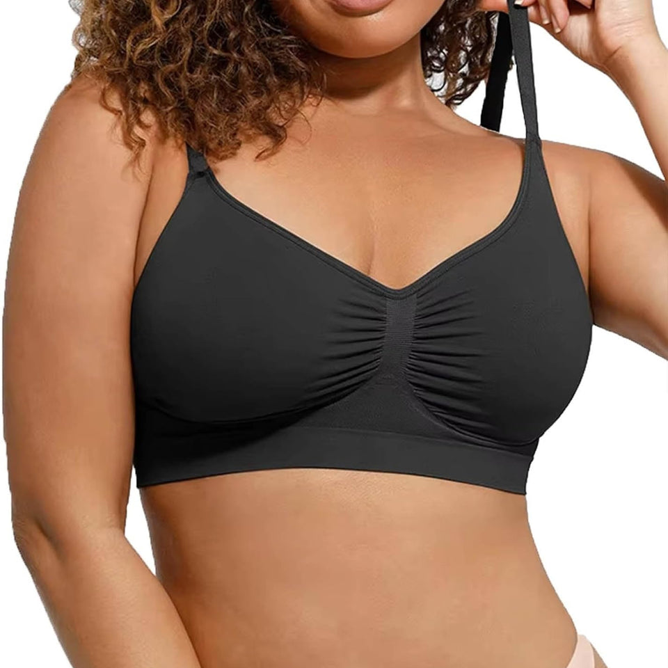 A close-up of a woman wearing a black wireless bralette with ruched cups and thin adjustable shoulder straps, shown against a plain white background.