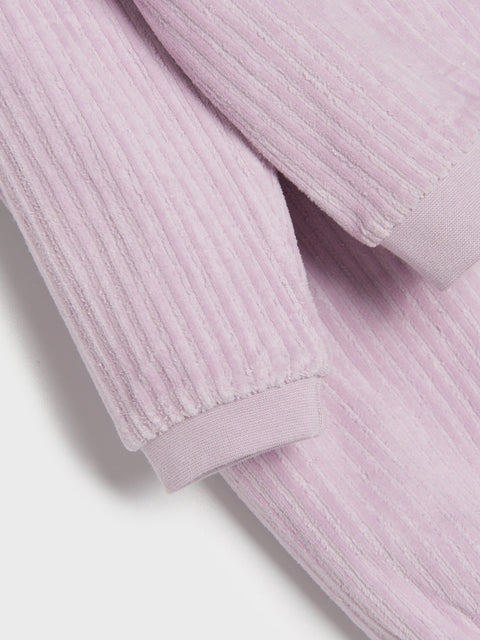 Close-up of a light purple ribbed fabric texture