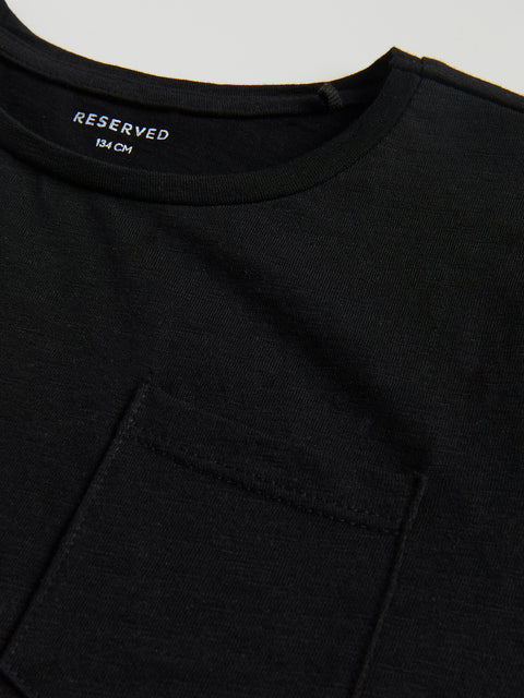 Black t-shirt with a pocket and 'RESERVED' label on a light gray background