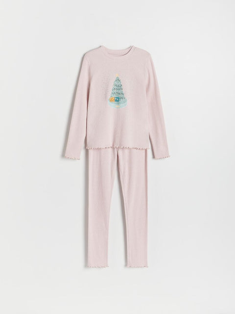 Pink pajama set with a design on the shirt against a white background