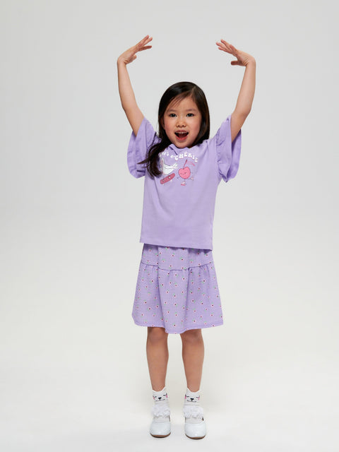 Child wearing a purple outfit with matching top and skirt on a white background