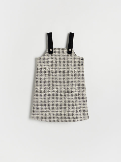 Plaid dress with black straps on a white background