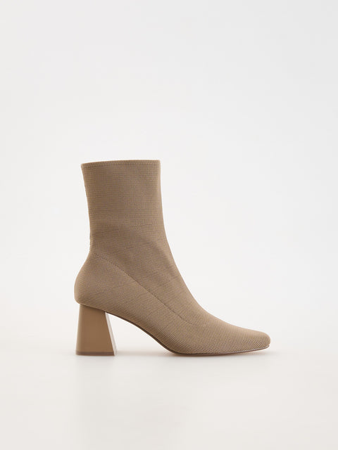 Beige sock boot on a white background