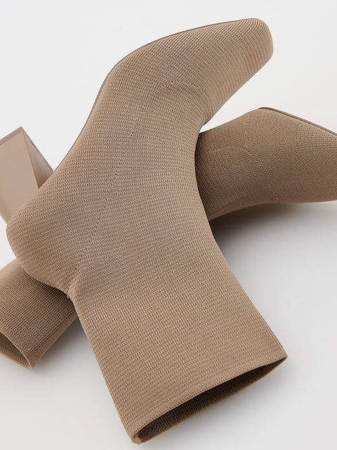 Pair of brown sock-like shoes on a white background