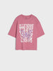 Pink t-shirt with graphic design and text on a light gray background