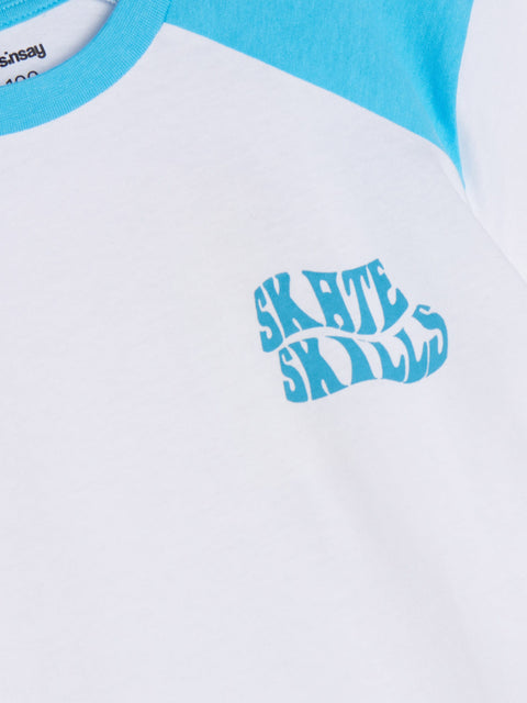 Close-up of a t-shirt with 'Skate Skills' logo and blue sleeves.