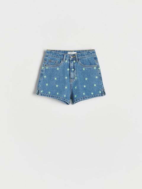 Blue denim shorts with star patterns on a light gray background