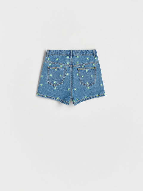 Blue denim shorts with star pattern on a light gray background
