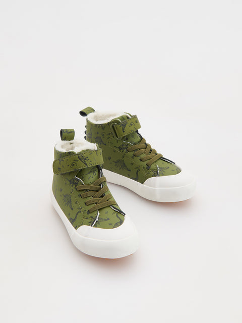 Green high-top sneakers with white soles on a light gray background