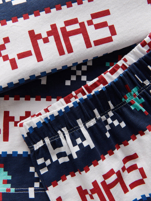 Pixelated 'M-X-MAS' text on a patterned fabric background