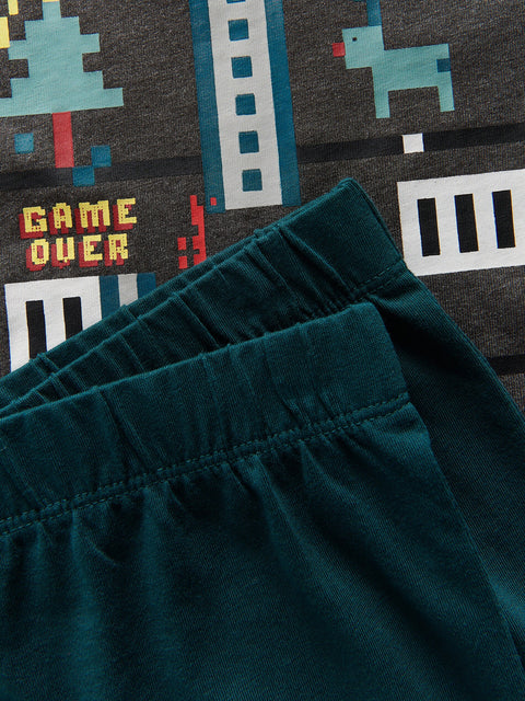 Teal shorts with a retro video game design on a dark background