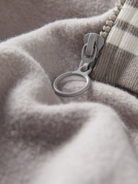 Close-up of a zipper on a textured fabric surface