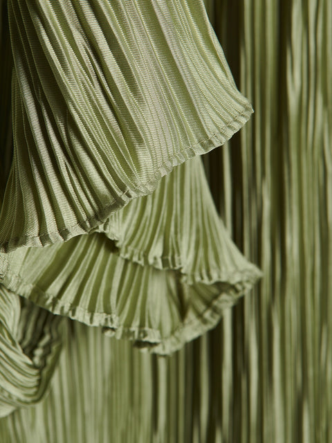 Close-up of a green pleated fabric with ruffles