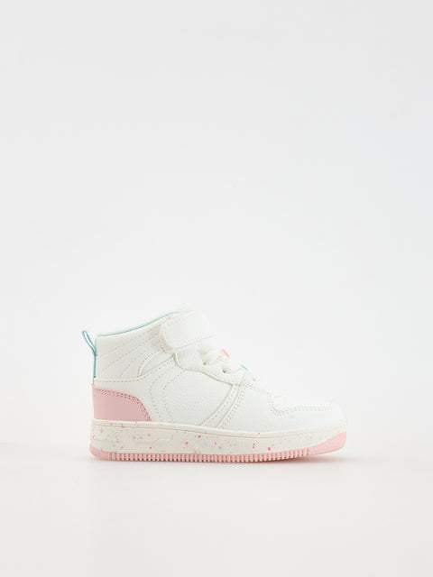 White high-top sneaker with pink accents on a light gray background