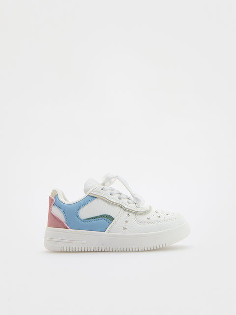 White sneaker with colorful accents on a white background