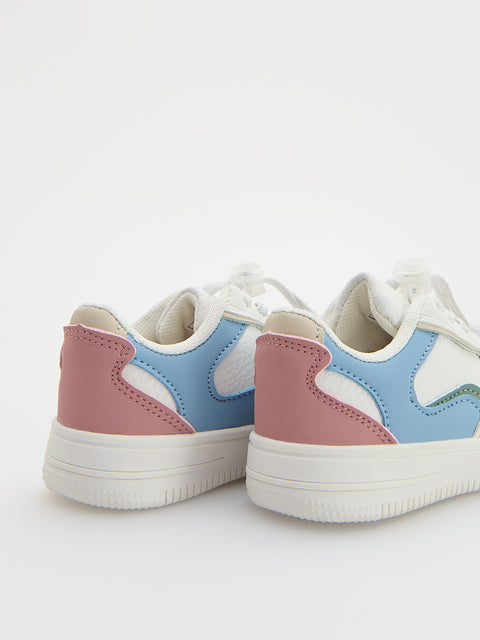 Pair of pastel-colored sneakers on a white background