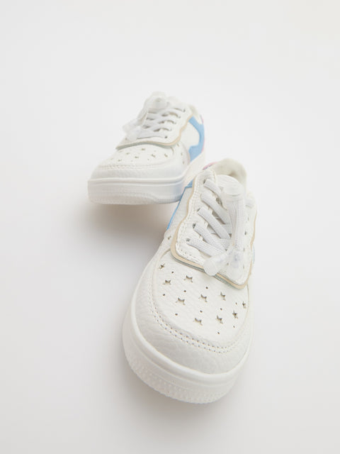White sneakers with blue accents on a light gray background