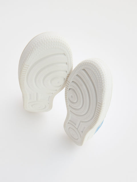 White shoe insole with a textured sole on a light gray background