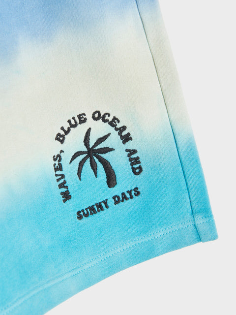 Tie-dye shirt with palm tree design and text on a gradient background