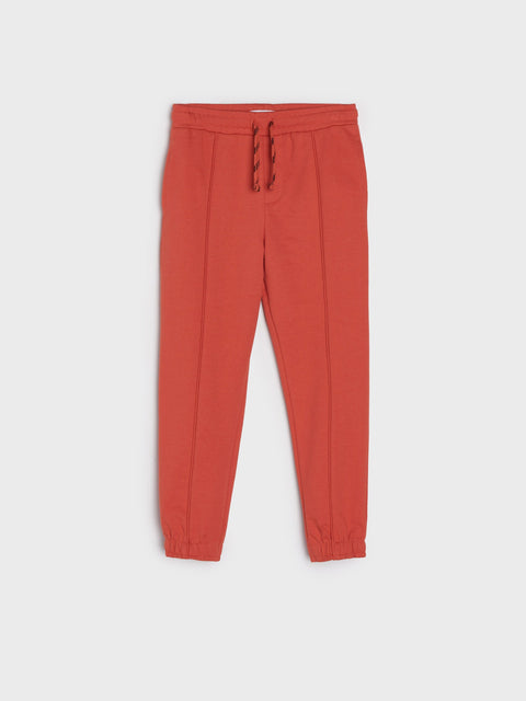 Red jogger pants on a white background