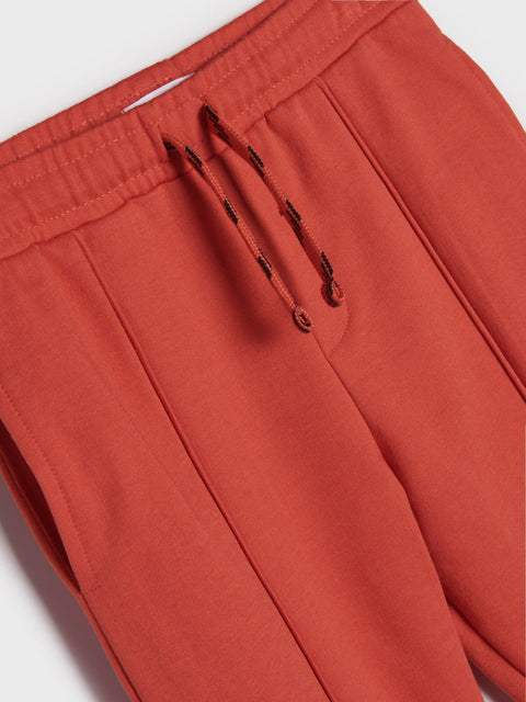 Close-up of red pants with a drawstring on a white background