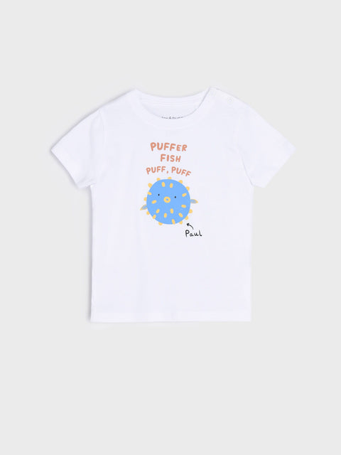 White t-shirt with a blue puffer fish graphic and text on a beige background