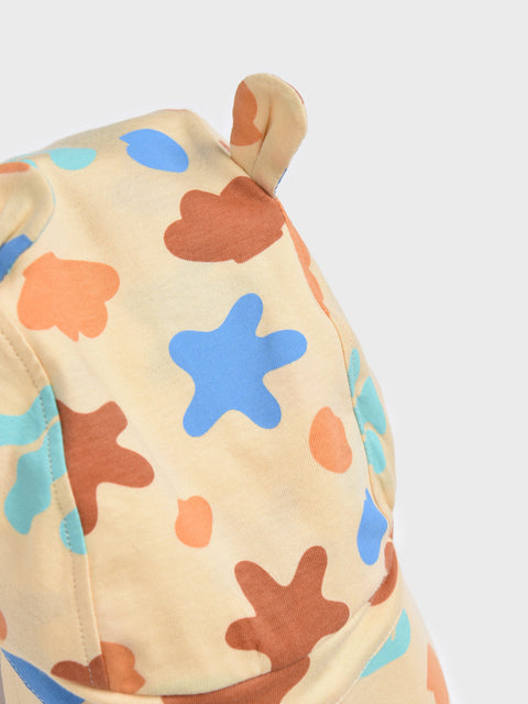 Children's outfit with star and leaf pattern on a plain background
