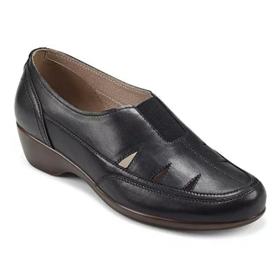 A black leather slip-on wedge shoe with decorative cutout details on the toe and side, shown from a three-quarters angle against a white background.