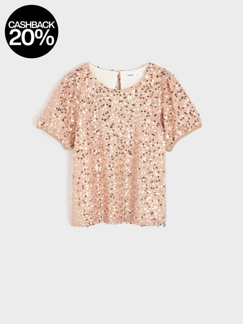 Rose gold sequin top on a light gray background