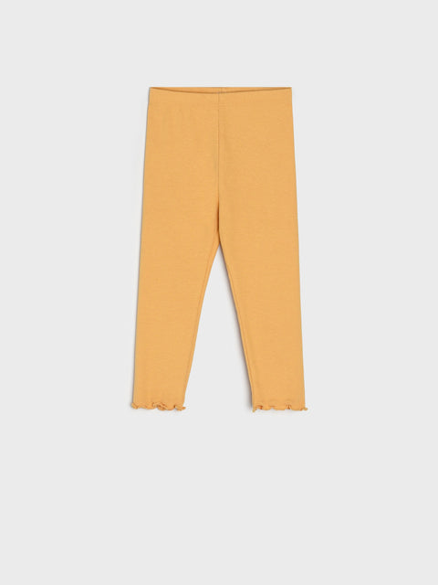 Mustard yellow leggings on a light gray background
