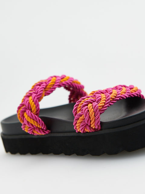 Pink and orange braided sandals on a white background