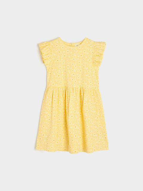 Yellow dress with a subtle pattern on a light gray background