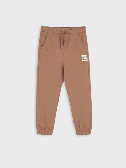 Brown sweatpants with a patch on a white background