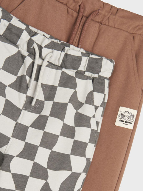 Brown and checkered shorts with a brand label on a white background