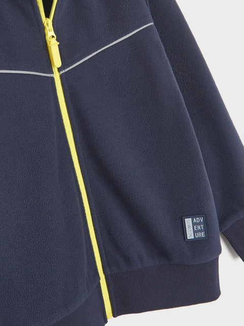 Navy blue jacket with yellow zipper and 'Adventure' logo on a white background
