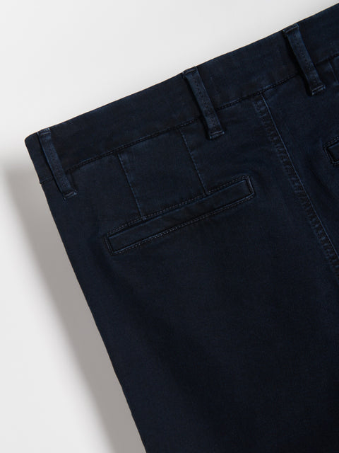 Close-up of dark blue pants on a white background