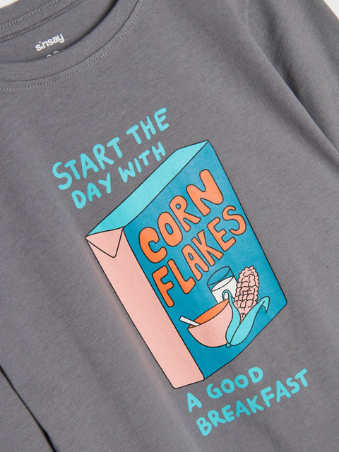 Gray t-shirt with a colorful corn flakes box graphic and text on a gray background