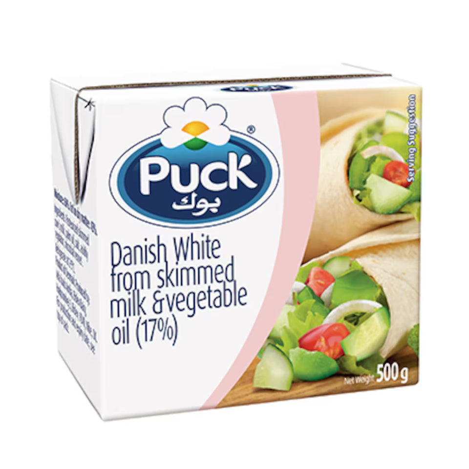 Puck Danish White cheese packaging with a wooden board and cheese slices on a white background