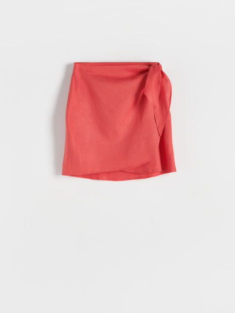 Red skirt with a tie detail on a white background